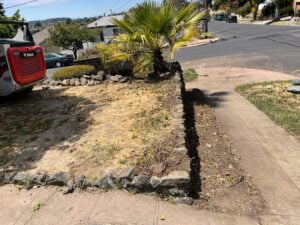 Retaining wall project before and after HT Paving and Sealcoating's intervention.