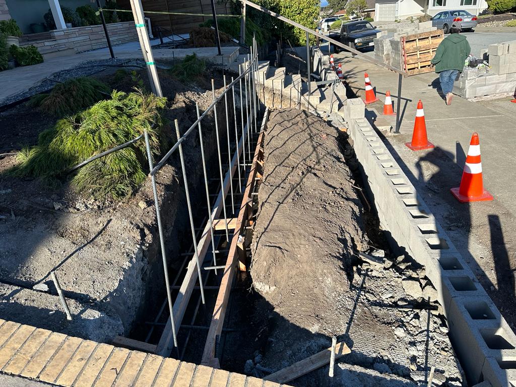 step-by-step construction process at HT Paving and Sealcoating's retaining wall project.